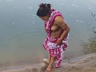 Desi Aunty enjoys a steamy outdoor shower close by her busty Indian costs